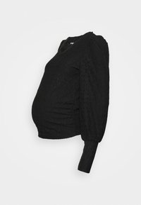 Top de maternidade preto com tecido texturizado, mangas curtas em balão e detalhe franzido na lateral para uma silhueta ajustada.