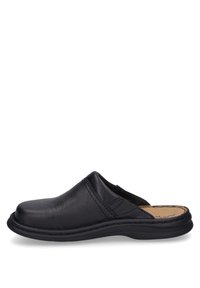 Black leather slip-on shoe with a rounded toe, stitched accents, and a rubber sole. Smooth texture and casual design.