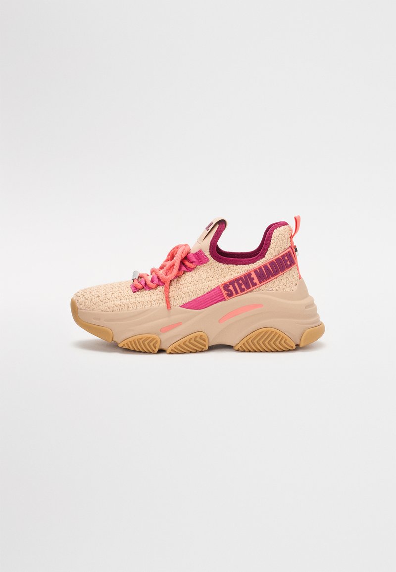Zapatilla deportiva beige con acentos en rosa, parte superior de punto texturizado, suela acolchada y marca en relieve. Cuenta con cordones redondos y una lengüeta.