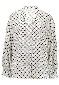 Blusa in seta con sfondo bianco, caratterizzata da un motivo a catena a diamanti neri e accenti a cuore. Chiusura frontale con bottoni e maniche a palloncino.