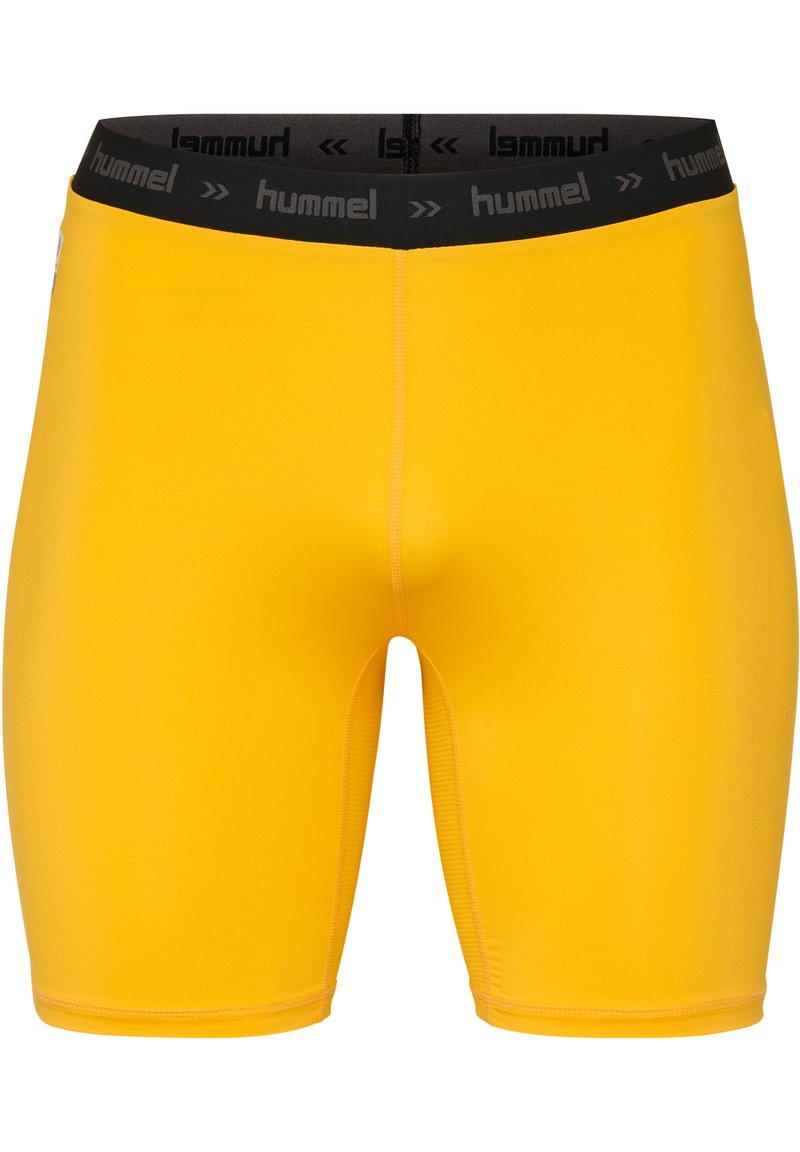 Gula idrottsshorts med en tajt passform, tillverkade av ett slätt material. Har en svart elastisk midja med "hummel"-logotyp.
