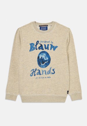 Sweatshirt beige à manches longues, avec le texte graphique bleu "Conçu par Blauw Hands" et un design circulaire bleu à l'avant.