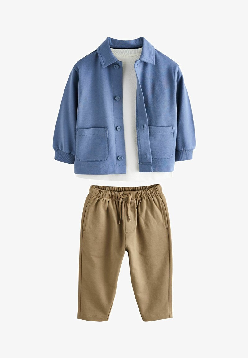 Chaqueta de forro polar azul con cierre de botones y dos bolsillos delanteros, combinada con pantalones beige con cintura elástica. Textura suave, diseño casual.