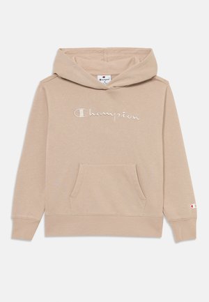 Bežs Champion hoody, izgatavots no mīksta auduma, ar priekšējo kangauru kabatu, izšuvumu ar logotipu un ribota piedurknes. Klasisks dizains ar kapuci.