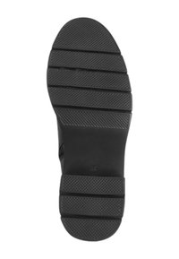 Black rubber shoe sole with horizontal grooves and textured patterns for grip. Features a rounded toe and flat design.