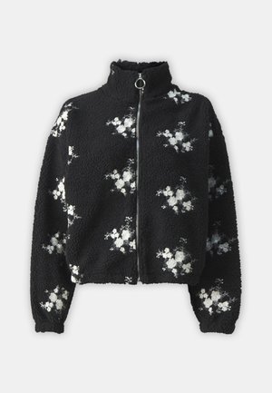 Black fleece jacket with high collar and front zipper, featuring white floral embroidery on the fabric. Soft texture, relaxed fit, long sleeves.