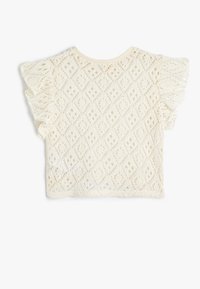 Top bianco in pizzo con motivi a diamante, maniche corte a sbuffo e scollatura rotonda, realizzato in tessuto leggero e testurizzato.