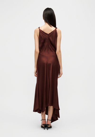 Φόρεμα από σατέν βουργουνδί με ρυθμιζόμενους ιμάντες, εφαρμοστό μπούστο και αέρινο ασύμμετρο τελείωμα. Διαθέτει απαλό ύφασμα και μινιμαλιστικές λεπτομέρειες.