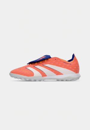Crampons de football orange avec des rayures blanches, empeigne texturée, accents bleus sur la languette et le talon, et une semelle en caoutchouc pour l'adhérence.