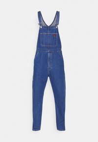 Tmavě modré riflové lacláče s nastavitelnými ramenními popruhy, přední kapsou a zúženými nohavicemi. Obsahují kovové kování a zesílené švy.