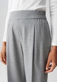 Grijze geblokte broek met een brede tailleband en plooien. Gemaakt van een gestructureerde stof, met een subtiel patroon en een ontspannen pasvorm.