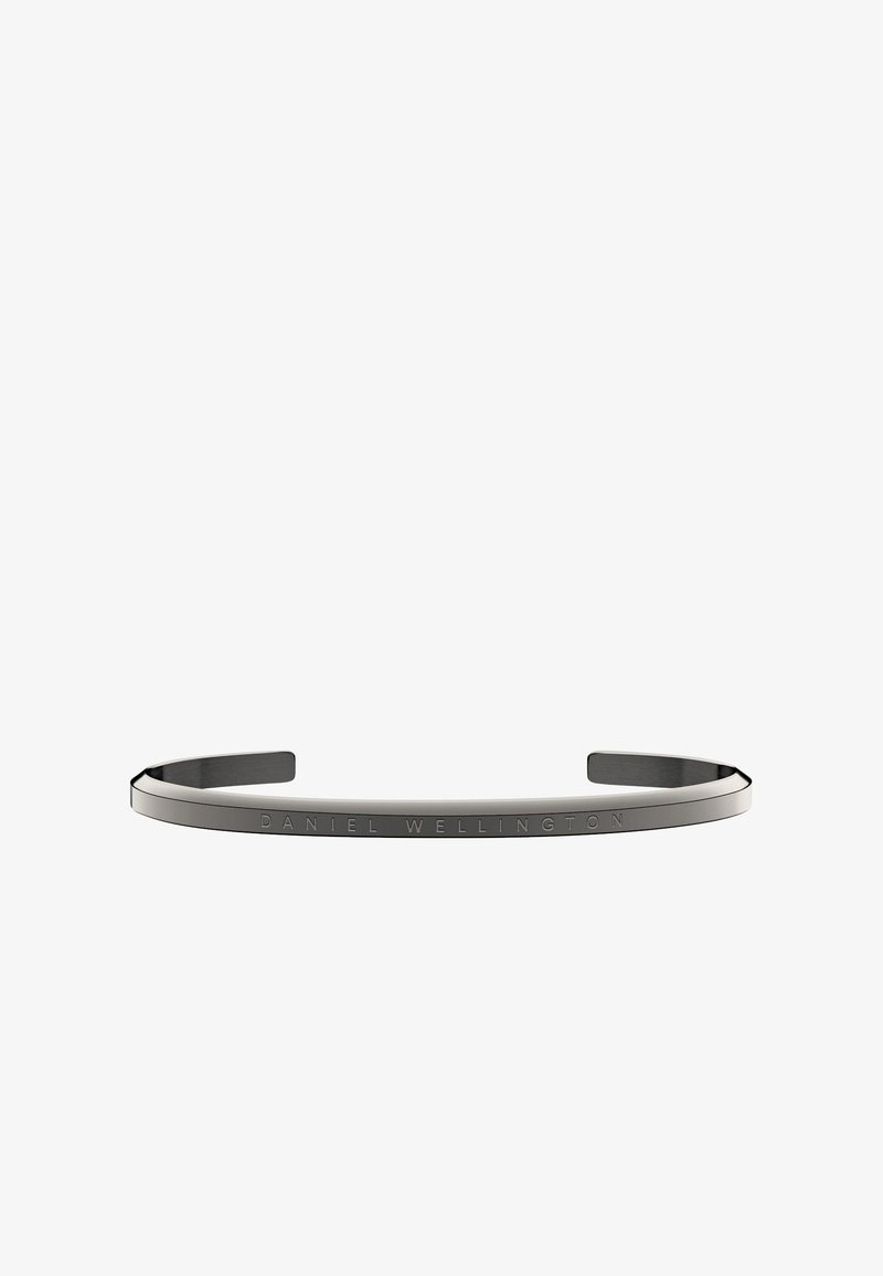Brăţară din metal negru cu un design simplu şi elegant. Textul gravat "DANIEL WELLINGTON" pe întreaga suprafaţă. Finisaj neted, mat.