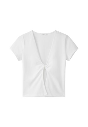 Haut blanc pour femmes à manches courtes, col en V, avec un nœud central torsadé et une découpe en forme de goutte d'eau à l'avant.