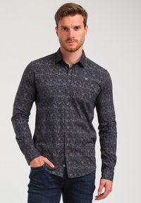 Camicia a maniche lunghe con bottoni in blu scuro con un motivo floreale sottile, realizzata in tessuto intrecciato con una texture liscia e una vestibilità su misura.