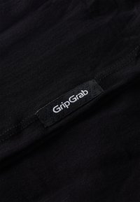 Black fabric with a smooth texture featuring a woven GripGrab label in black and white detailing near the edge.