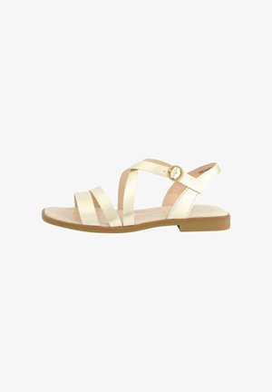 Sandali piatti con cinturini in oro metallico. Caratterizzati da più cinturini testurizzati e un dettaglio con fibbia circolare. Suola marrone chiaro con minimo grip.