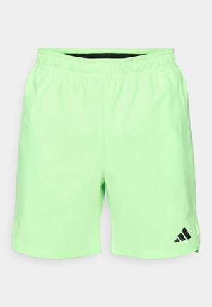 Light green athletic shorts with an elastic waistband, side pockets, and a black Adidas logo on the lower left. Smooth, lightweight material.