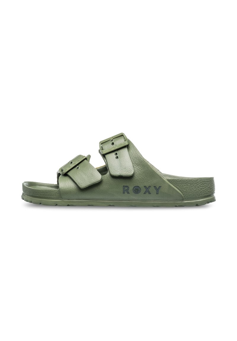 Green double-buckle slide sandal with textured synthetic straps and a padded footbed. Features branding on the side. Flat rubber sole.