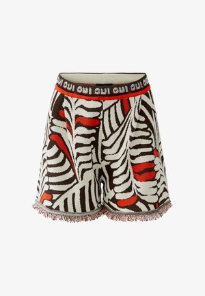 Gebreide korte broek met abstract bruin, wit en rood zebra-achtig dessin, franjes aan de zoom en een elastische tailleband met herhaalde tekst “oui”.