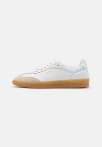 White sneakers with a smooth leather upper, suede toe cap, and a gum rubber sole. Features branding on the side and textured accents.