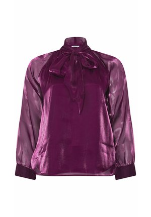 Blusa di seta di un profondo viola con colletto alto e dettaglio a fiocco. Presenta maniche lunghe trasparenti e un corpo solido, leggermente lucido.