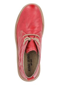 Rød læder snøresko med beige snørebånd, rund tå og en lys brune gummisål. Markenavn trykt på indersålen. Glat tekstur.