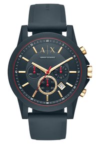 Black silicone strap watch with a round black dial, gold accents, red markers, three sub-dials, and a date window at 6 o’clock.