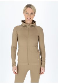 Beige Zip-Hoodie mit figurbetontem Design, langen Ärmeln und Kapuze. Aus geripptem Material gefertigt, mit einem Logo-Detail am Saum.