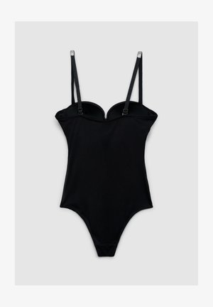 Body nero intero con spalline sottili regolabili e dettagli in strass su uno sfondo grigio chiaro uniforme.