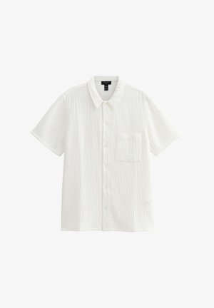 Kurzärmliges, weißes Hemd aus strukturiertem Stoff. Mit durchgehender Knopfleiste und einer einzelnen Brusttasche. Sauberes, einfaches Design.