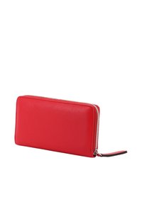 Red leather zipper wallet with textured surface, rectangular shape, contrasting zipper, and a decorative strip on the zipper pull.