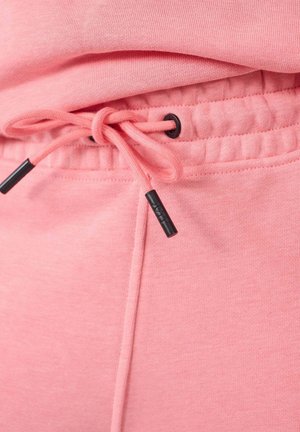 Roze sweatpants met een trekkoord in de taille, voorzien van zwarte aglets en een zachte, gestructureerde stof. Elastische boorden bij de enkels.