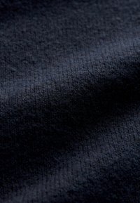 Dark navy fabric with a textured surface. The material appears soft, with subtle variations in shading and a uniform weave pattern.