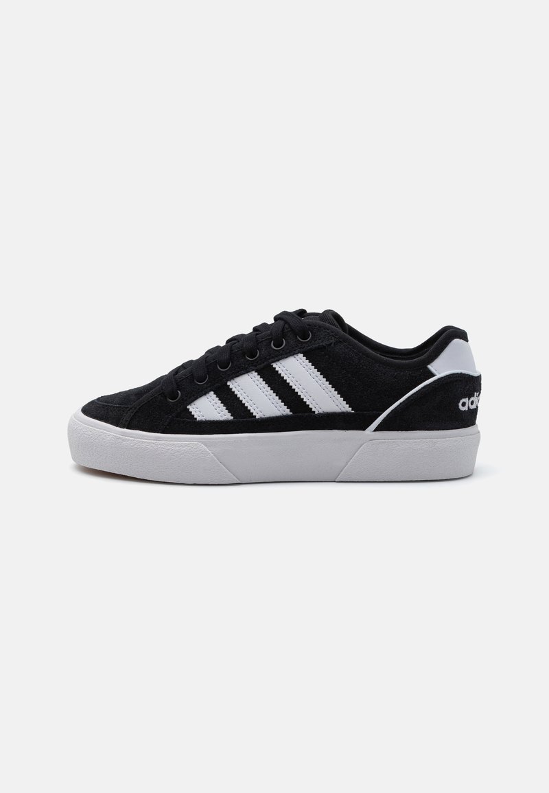 Black suede sneaker with white three-stripes design, white rubber sole, and black accents. Features round laces and padded collar.