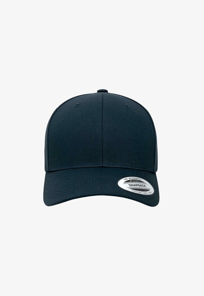 Căciulă snapback de culoare albastru închis, cu un vârf structurat, margine curbată și un etichetă gri cu logo pe partea din stânga față. Textură de țesătură netedă.