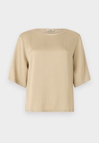 Beige bomull t-skjorte med rund hals, korte ermer og løs passform. Glatt tekstur og ingen synlige mønstre eller dekorasjoner.