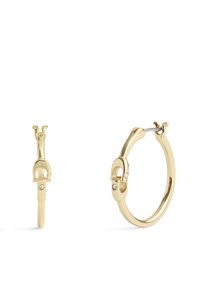 Boucles d'oreilles créoles en or avec un design de fermoir unique, ornées de deux petites pierres transparentes, texture lisse et finition polie.