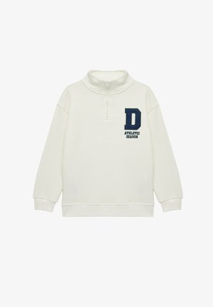 Sudadera de color crema, texturizada, con cuello alto, medio cierre y bordado en azul marino de "D" y "TEMPORADA ATLÉTICA" en la parte delantera.