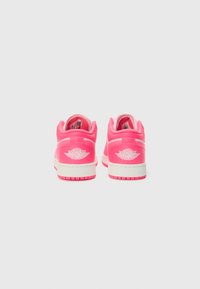 Pink sneakers with a smooth texture, featuring a white logo on the heel, white midsole, and pink outsole. Rear view shows padded collar.