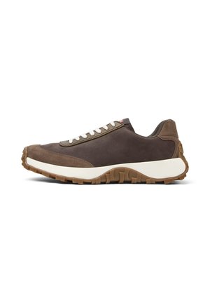 Dark brown sneaker with white laces, featuring a chunky sole and smooth fabric. Side view highlights the shoe's design and texture.
