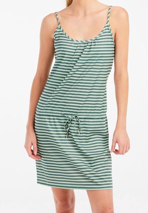 Woman wearing a sleeveless, green and gray horizontal striped dress with a drawstring waist on a white background.