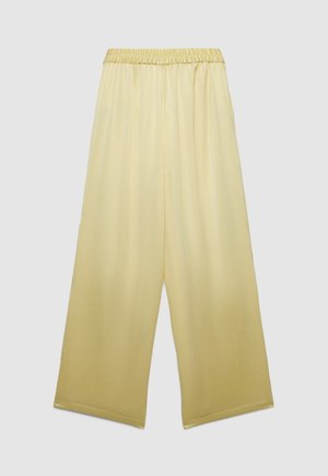 Loose-fitting, wide-leg, pale yellow pants with an elastic waistband, made from lightweight, textured fabric.