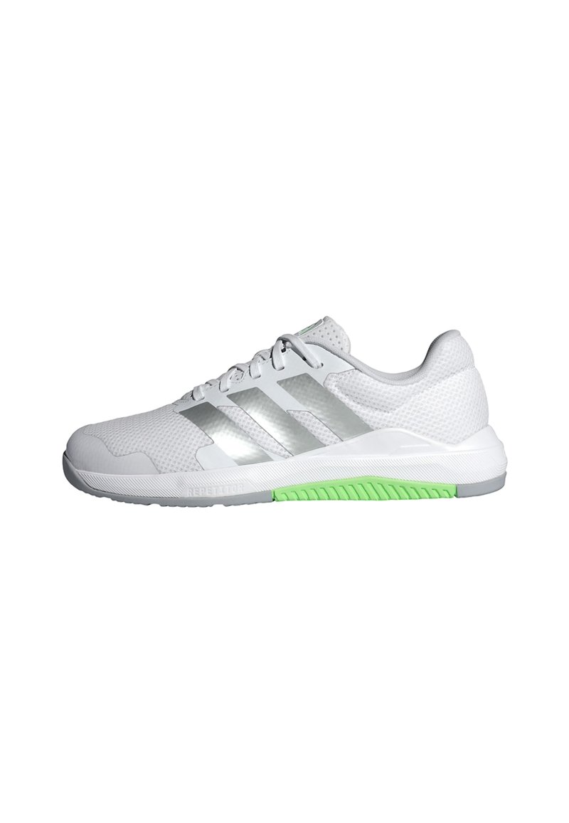 White athletic shoe with mesh upper, reflective silver stripes, and green rubber outsole. Features lace closure and padded collar for comfort.