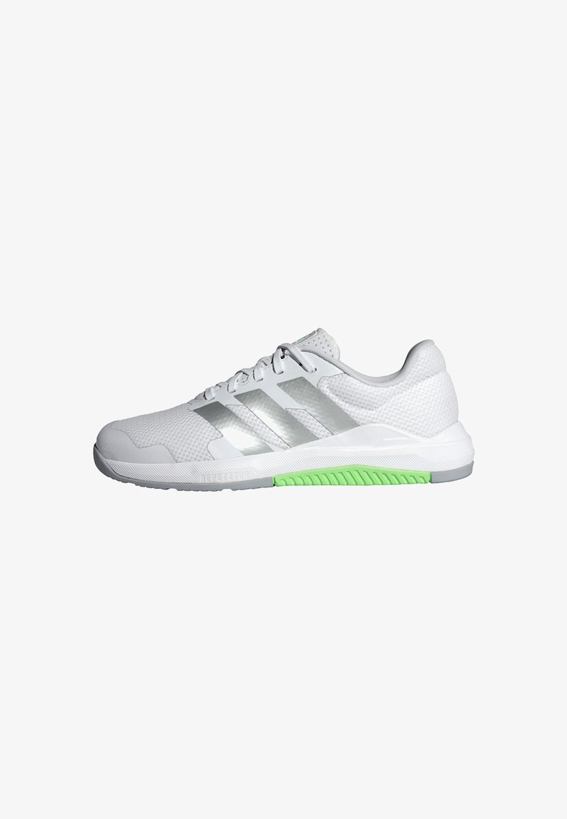 White athletic shoe with mesh upper, reflective silver stripes, and green rubber outsole. Features lace closure and padded collar for comfort.