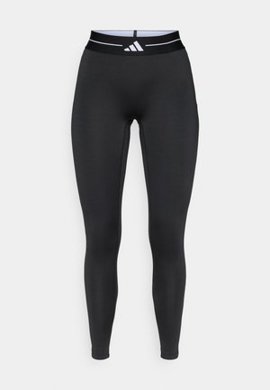 Μαύρο αθλητικό κολάν από ελαστικό υλικό, με ψηλή μέση που έχει λευκή ριγέ λεπτομέρεια και λογότυπο της μάρκας. Ομαλή υφή.