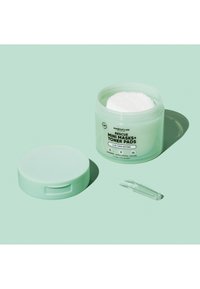 Open muntgroen potje met label "Rescue Mini Masks+ Toner Pads" met witte tonerpads erin, bijpassend deksel ernaast en een doorzichtige plastic spatel.
