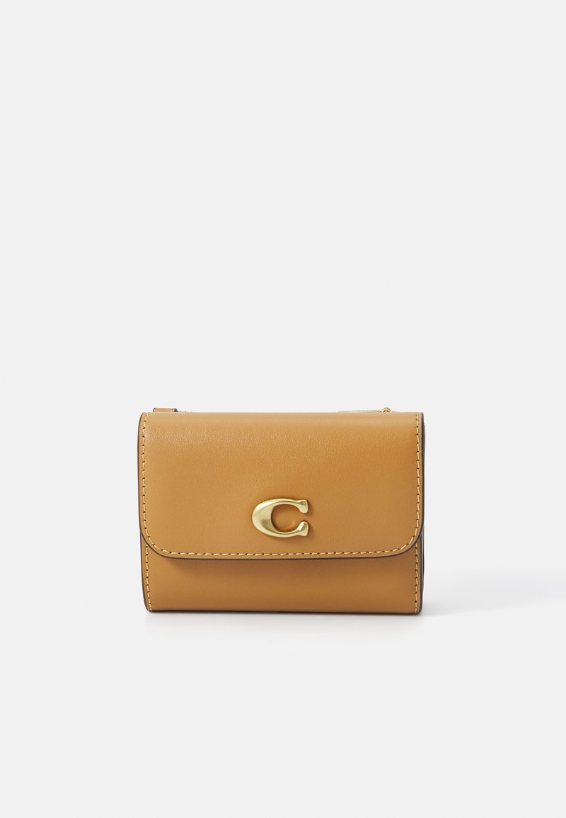 Tan leather wallet with a gold metal clasp, featuring simple stitching and a fold-over design. Smooth texture and compact shape.