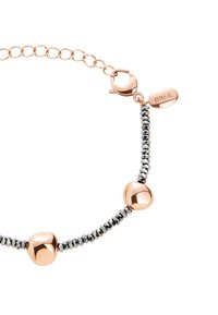 Pulsera de oro rosa que presenta tres cuentas suaves y redondeadas, alternando con cuentas facetadas negras, unidas por una delicada cadena y un cierre de langosta.
