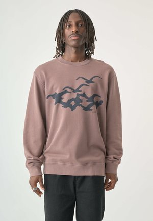 Übergroßer mauvefarbener Sweatshirt mit einem schwarzen Wellen- und Vogelgraphic über der Brust. Aus weichem Baumwollmaterial, mit gerippten Bündchen und Rundhalsausschnitt.