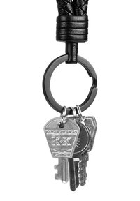 Keychain with braided black leather strap, metal ring, and three silver keys of different shapes and designs attached.
